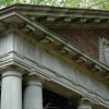 <p><strong>Neoclassical, details</strong>: Doric pediment, entablature, and capitals reflect Classical precedents in the design of the center pavilion of the Administration Building (Building 13). East facade, view northwest, November 2005.</p>